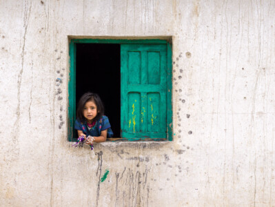 Girl leaning out of the window. 2016 Guatemala